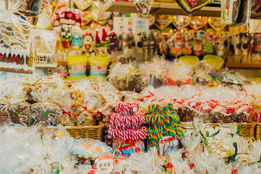 View of different colourful Christmas sweet food and decoration at the market on main square of Krakow city in warm light