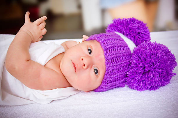 the baby in a violet knitted stock photo