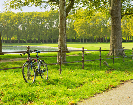 Bicycle at the green grass near a lake in Versaille, France, No people