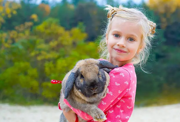 Photo of Portrait of beautiful girl with rabbit