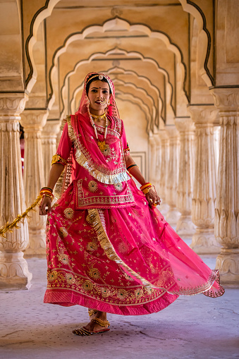 Young Indian woman, wearing traditional Rajasthani dress, posing in Jaipur city, Rajasthan.