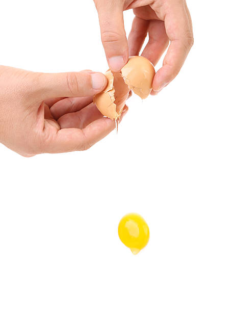 istock Closeup of broken egg in hand 186990123