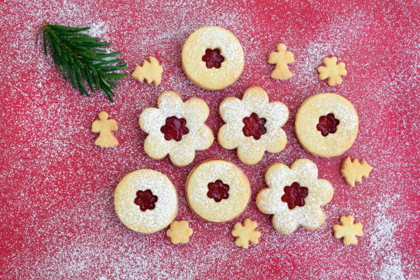 istock Linzer cookies on red sugared background with fir twig 1869902945