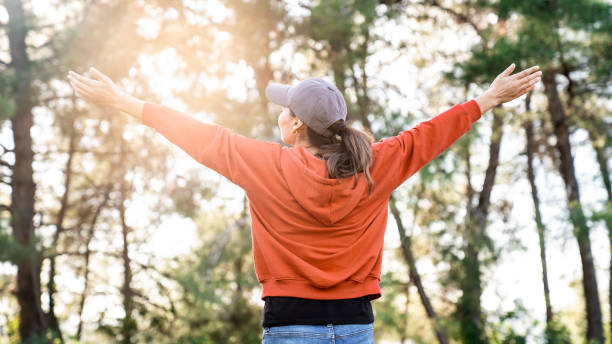 istock Woman arms outstretched in nature 1869906197