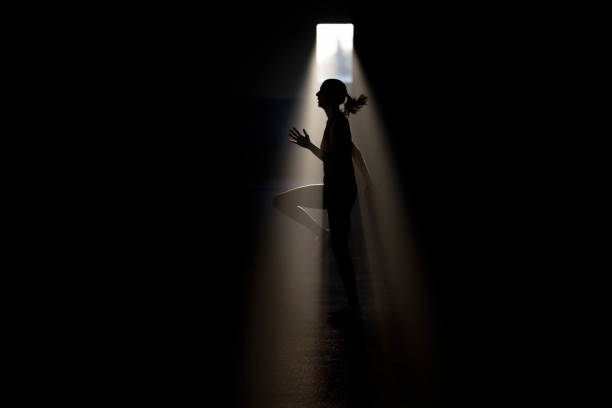 istock Female athlete running on spot against a light at night 1869912566
