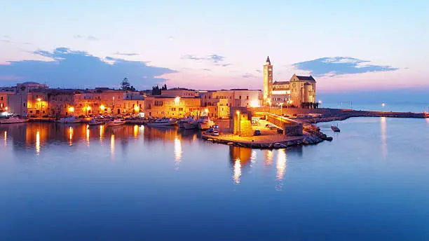 View of Trani (IT) and its harbor from a vantage point. Of particular note the old fishing boats, used by local fishermen, and the Cathedral of "St. Nicholas the Pilgrim" (1200 AD) example of Apulian Romanesque architecture, included in the list of "Italian Wonders" was built during the Norman rule.