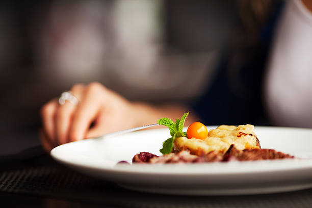 istock Female hand with a dinner at restaurant 186991850
