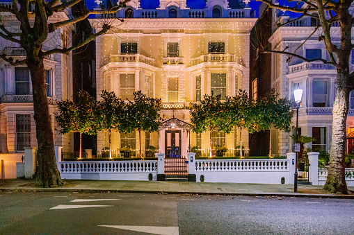 London, UK - 11 December, 2023: tasteful Christmas decorations and lights outside luxury houses in the affluent Holland Park area of London, UK.