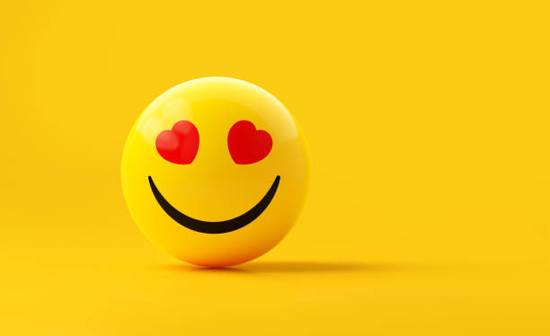 istock Yellow Sphere Textured With Happy Face Emoji On Yellow Background 1869923199