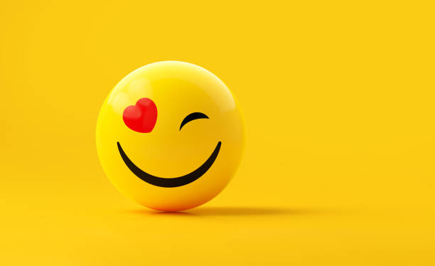 istock Yellow Sphere Textured With Happy Face Emoji On Yellow Background 1869927343
