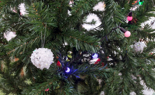 istock Close up Christmas Tree with Decorations with lights indoors. 1869928389