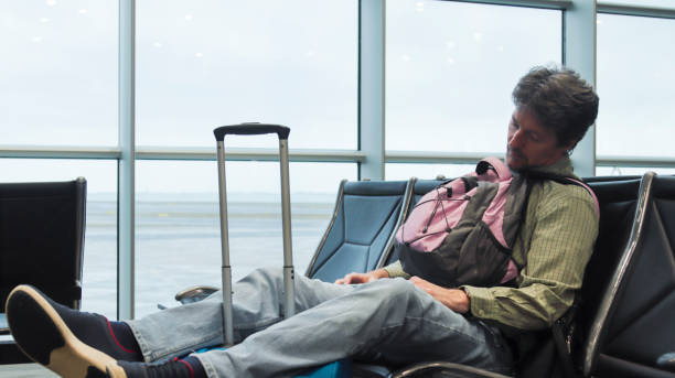 istock Man stuck at the airport sleeping 1869932110