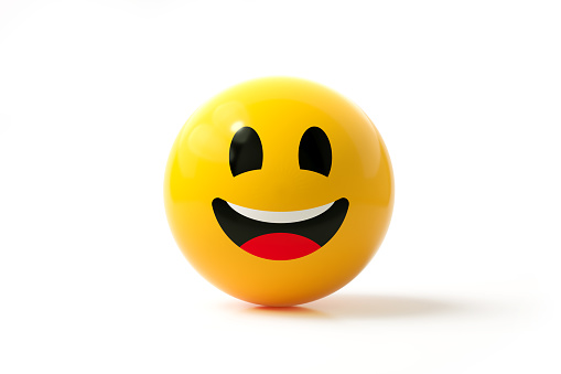 Yellow sphere textured with happy face emoji on white background. Horizontal composition.