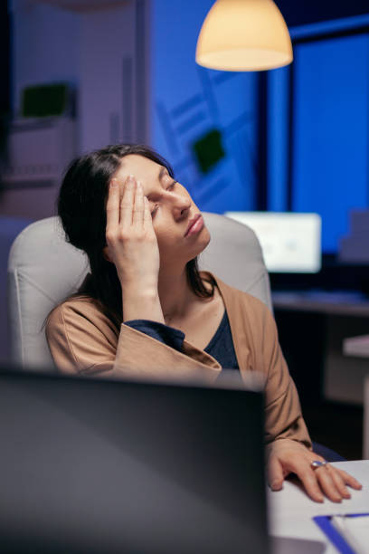 istock Tired businesswoman keeping eyes closed 1869937340