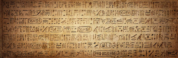 istock Old Egyptian hieroglyphs on an ancient background. Wide historical background. Ancient Egyptian hieroglyphs as a symbol of the history of the Earth. 1869941202