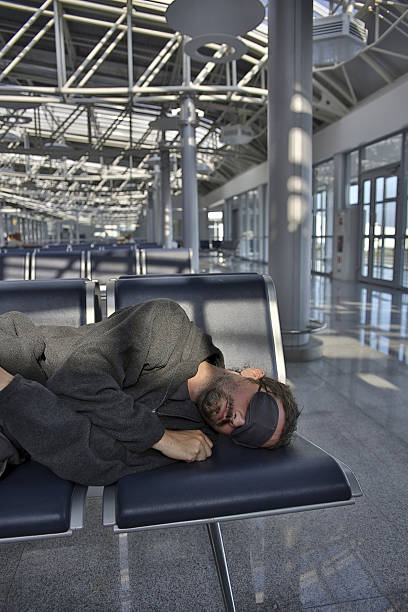 istock sleeping in airport with eye cover 186994477