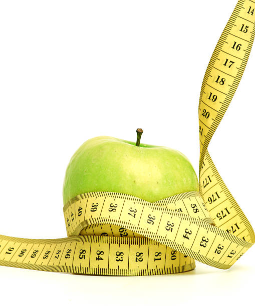 istock green apple with a heart symbol against white background 186995127