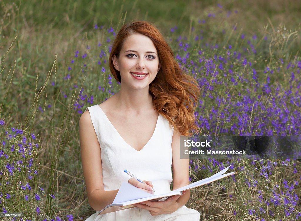 Redhead girl with note at outdoor Adult Stock Photo