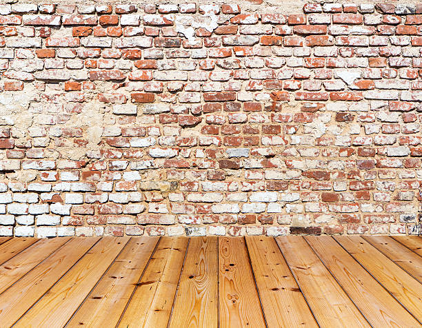 istock Old brick wall on wood floor 186995477