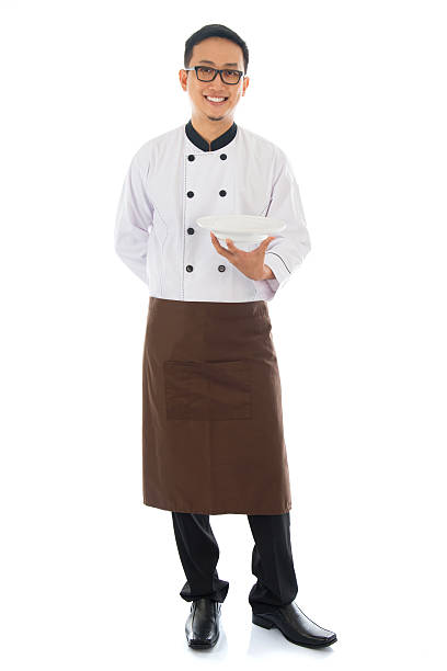 Asian chef holding an empty plate Full body Asian chef holding an empty plate, standing isolated on white background. japanese chef stock pictures, royalty-free photos & images