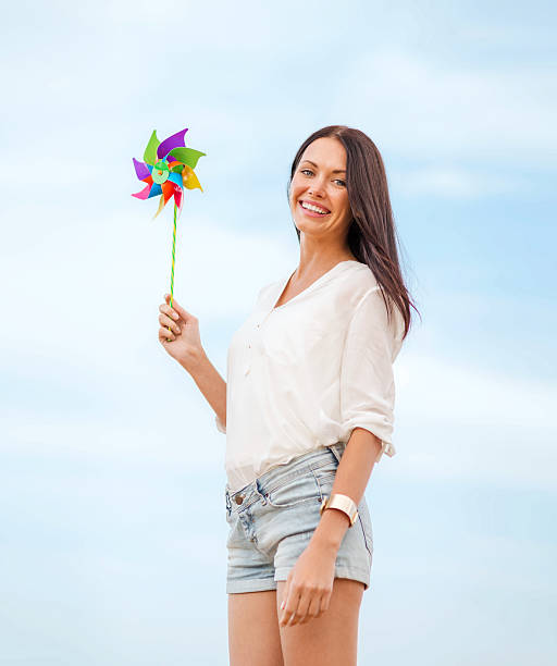 istock girl with windmill toy on the beach 186997860