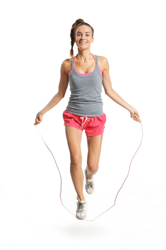 happy woman exercising with a jump rope