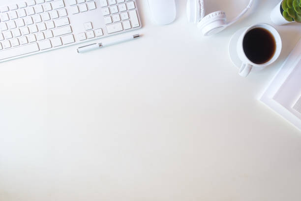 istock Office desk with notebook, coffee , wireless keyboard and houseplant. Top view with copy space. 1869980953