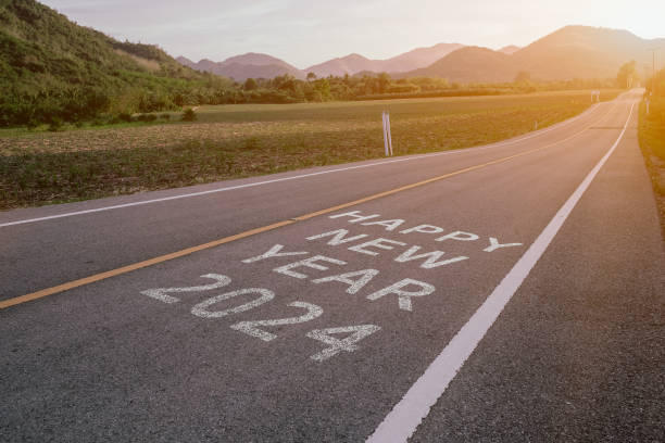 istock The words Happy New Year 2024 written on an empty road . 1869981484