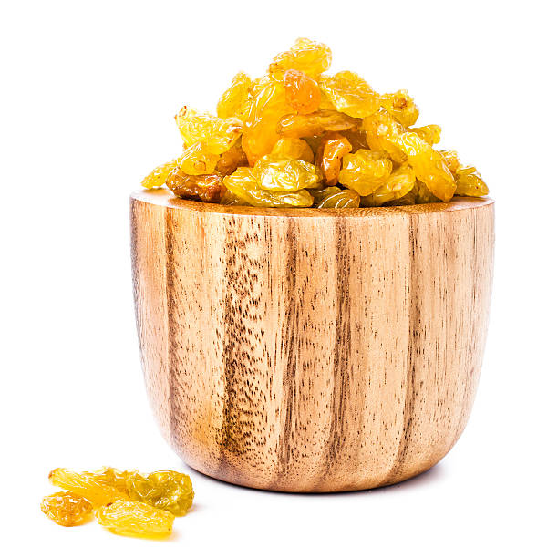 Golden Shiny Raisins isolated on white background