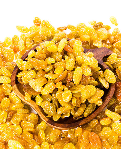Yellow Golden Shiny Raisins isolated on white background, nacro.
