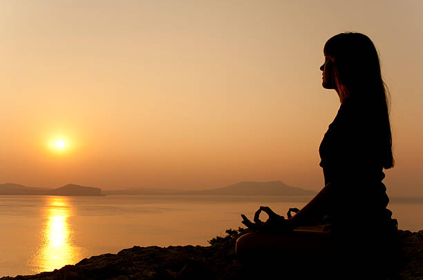 istock yoga pose silhouette at sunrise 186998601