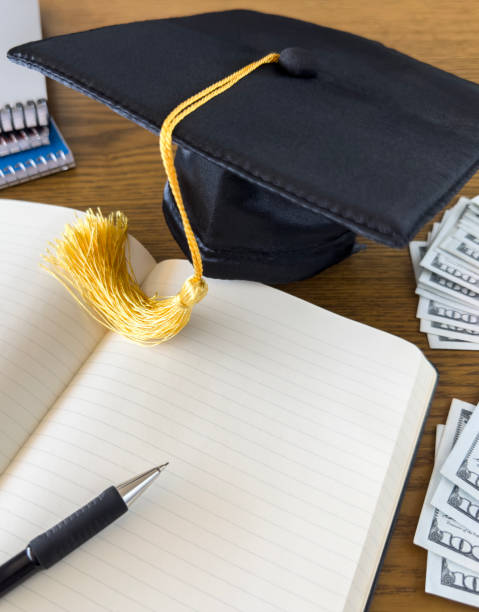 istock Saving tuition money 
mortarboard and 100 dollar bills 1869986221