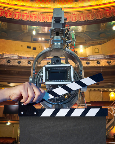 Film slate in front of a movie camera on a film set