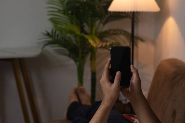 istock Men's hands on the table use mobile phones, technology, communications, the Internet. 1869988310