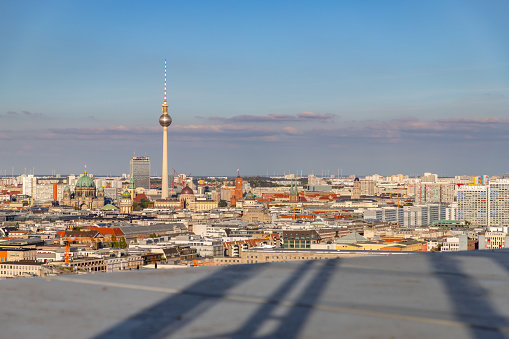A picture of some Berlin landmarks as seen from afar, such as the Berliner Fernsehturm, the Berlin Cathedral and the Berlin Palace.