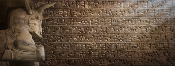 istock Ancient cuneiform Sumerian text and bull statue, a mythical Assyrian deity. Historical background on the theme of civilizations of Assyria, Mesopotamia, Babylon, interfluve, Sumerian. 1869989907
