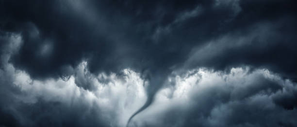 istock The typhoon is born, a tornado in a stormy dark sky with black clouds and a strong wind. Panoramic image. Concept on the theme of weather, natural disasters, tornadoes, typhoons, tornadoes, thunderstorm. 1869989919