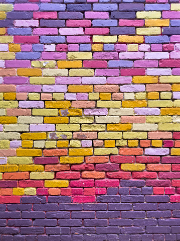 Full frame colorfully painted brick wall texture from a building