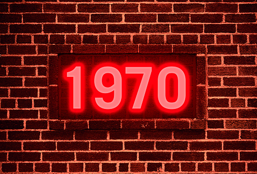 1970 Neon sign on a brick wall