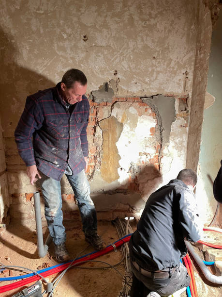 istock Electrician working working on building site, technicians install wiring 1869992054