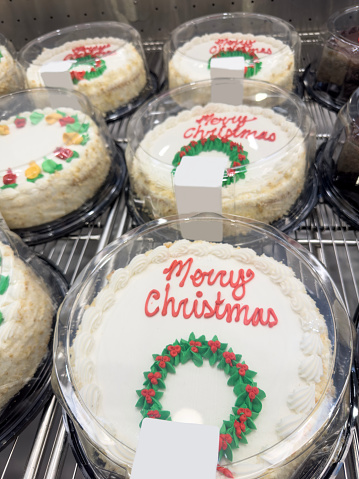 Looking down on a group of Christmas cakes in a bakery display