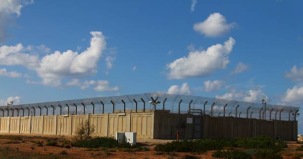 istock Secured industrial zone with concrete fence 186999495