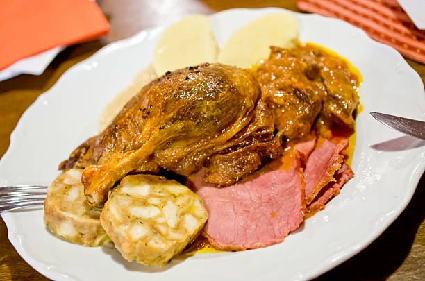 Ducks drumstick with cabbage, smoked ham and dumplings