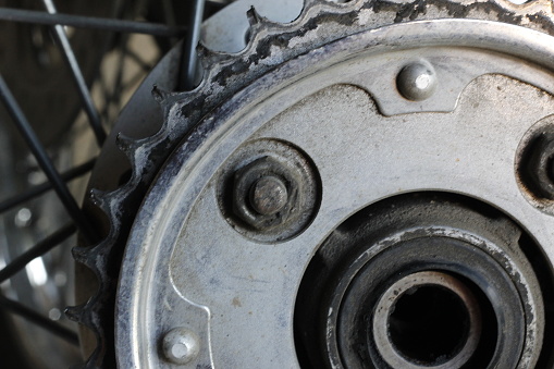 Motorcycle rear gear that needs to be replaced, used motorbike gear, old motorbike gear