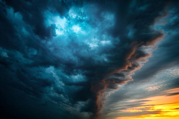 The typhoon is born, a tornado in a stormy dark sky with black clouds and a strong wind.  Concept on the theme of weather, natural disasters, tornadoes, typhoons, tornadoes, thunderstorm.