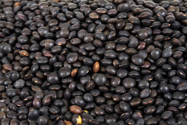 istock Heap of black lentil isolated on white 187002931