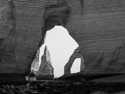 Chalk cliffs of Etretat (Normandy France) on a sunny day in summer, black and white