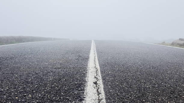 Asphalt road in winter fog