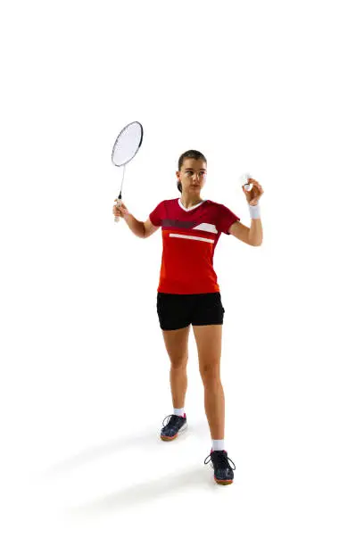 Photo of Full length portrait of attractive young girl training hard before championship against white studio background. Concept of healthy lifestyle.