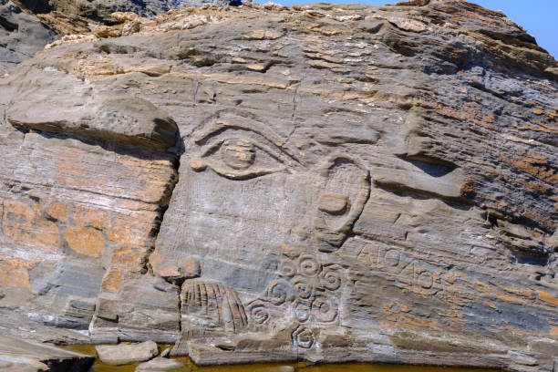 istock God Aeolus carved on the rock at Kavalourko Beach 1870047325